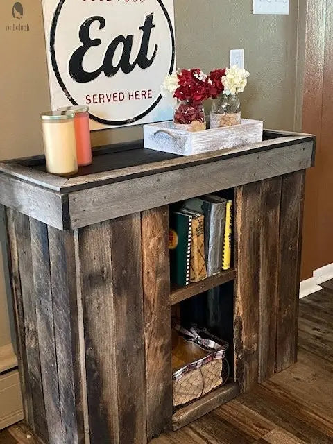 Red Cloak Wood Designs sofa table cabinet staged with florals and books – built from reclaimed barnwood for cozy kitchen or entryway use.