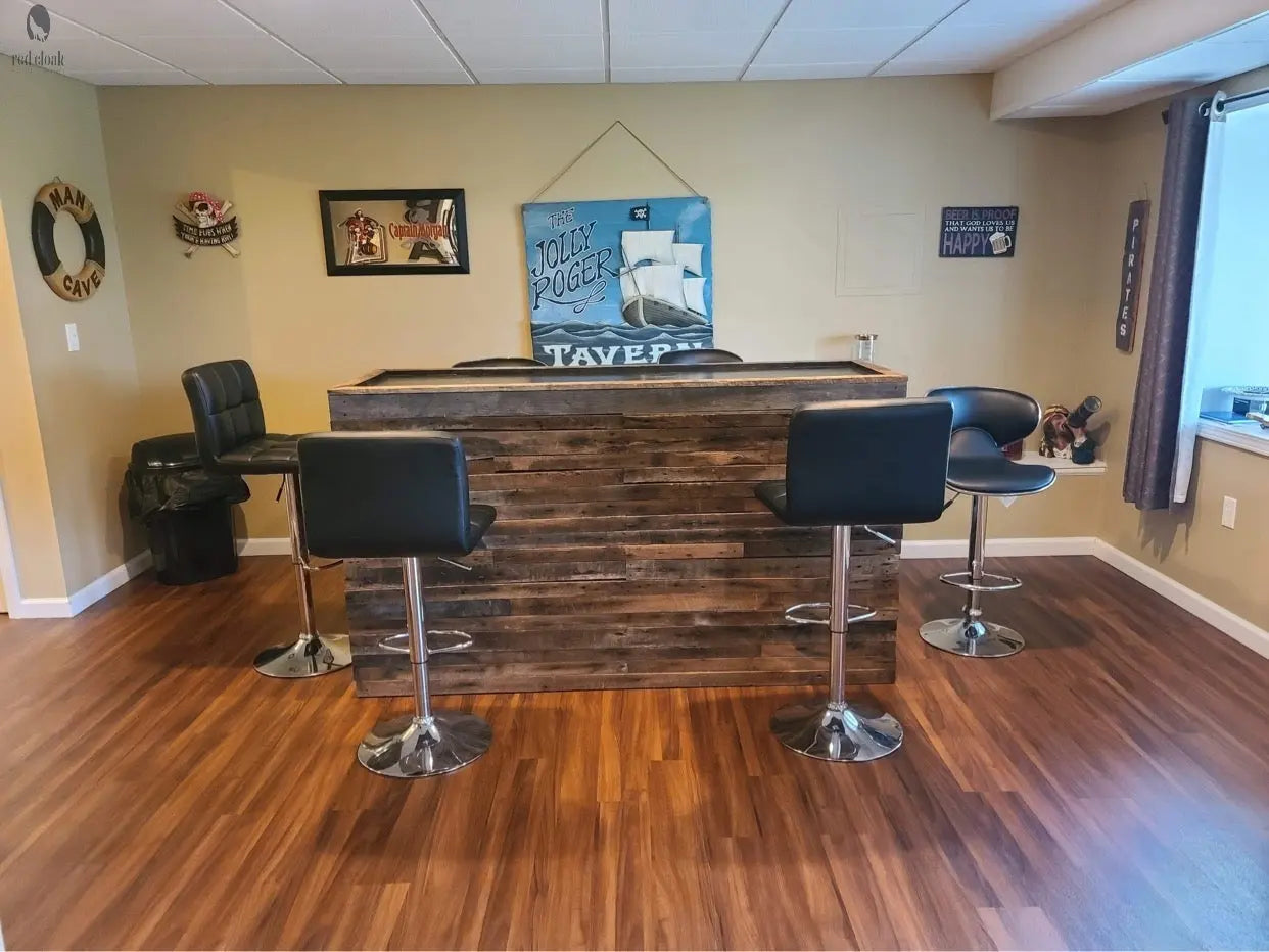 Custom wood bar with dark reclaimed panels in basement man cave
