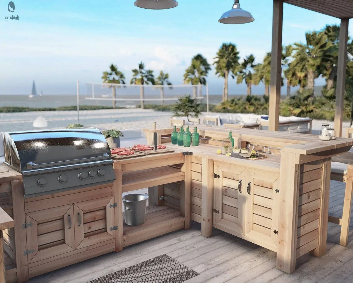 Outdoor beach bar with built-in grill and wooden sink base, handcrafted by Red Cloak with rustic detail and ocean backdrop