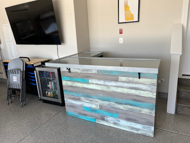 Handmade coastal bar with L shape design and built-in mini fridge, custom-painted barnwood by Red Cloak Wood Designs.