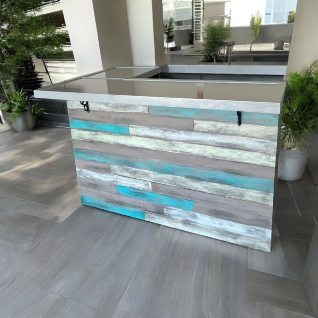 Modern patio setup with a coastal L shaped bar in blue and gray tones, built by Red Cloak Wood Designs from reclaimed barnwood.