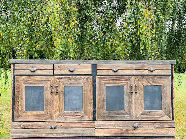Front-facing view of reclaimed wood back bar cabinet with four black panel doors and upper drawers, built from 200-year-old barn wood.