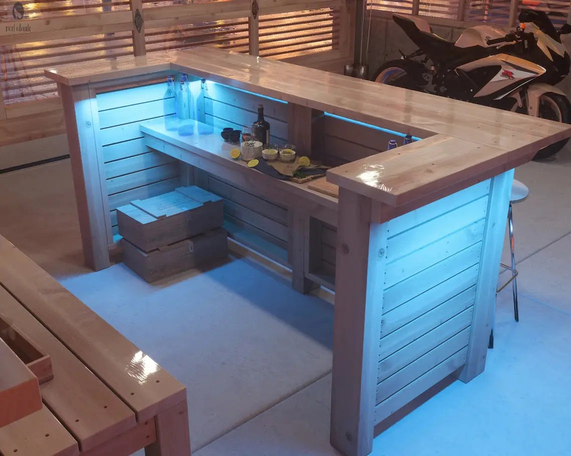 nterior view of Baby Squatch wood bar with shelving and blue LED lighting, handmade by Red Cloak