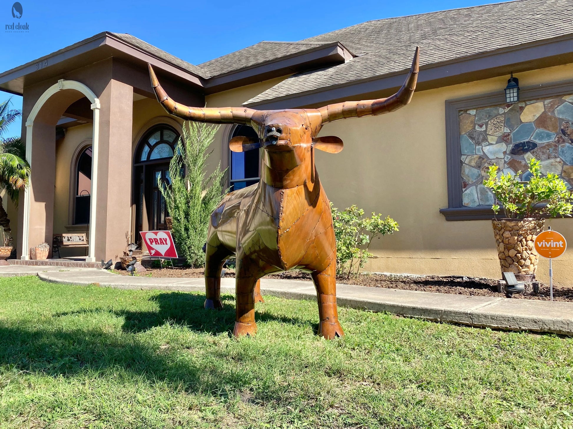 Full view of Long Horn Steer BBQ Grill on lawn in front of house – custom outdoor grill with horns. Handmade by Red Cloak Wood Designs