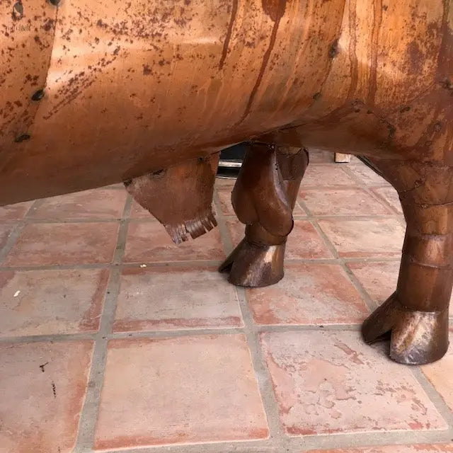 close-up of handmade longhorn grill leg detail with rust patina steel, Red Cloak Wood Designs, backyard cooking centerpiece. Handmade by Red Cloak Wood Designs