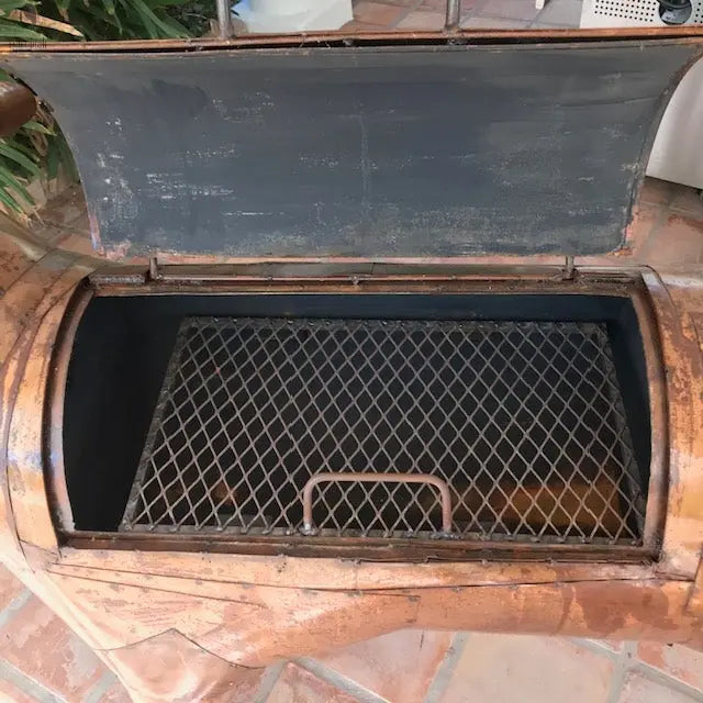 large open grilling chamber of longhorn BBQ with lifted lid and diamond grate, Red Cloak outdoor grill. Handmade by Red Cloak Wood Designs
