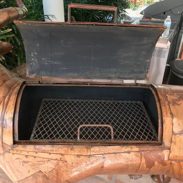 closeup of open lid on copper longhorn BBQ grill showcasing custom handcrafted outdoor smoker. Handmade by Red Cloak Wood Designs