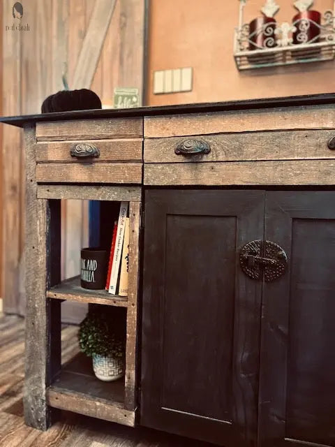 Detail of open shelving with books and black cabinet doors on handmade kitchen island. Made by Red Cloak Wood Designs