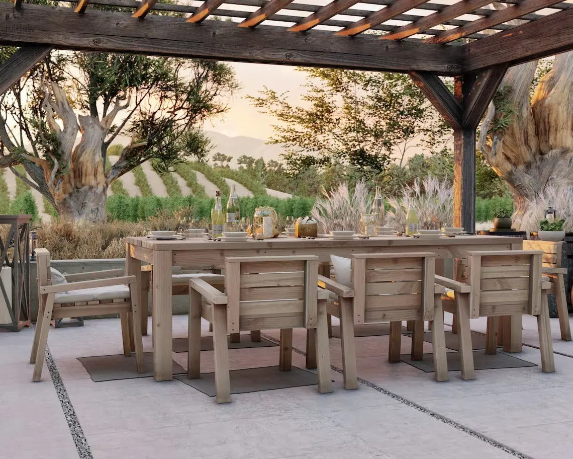 Rustic outdoor dining set with eight wide chairs under a pergola in a landscaped backyard setting