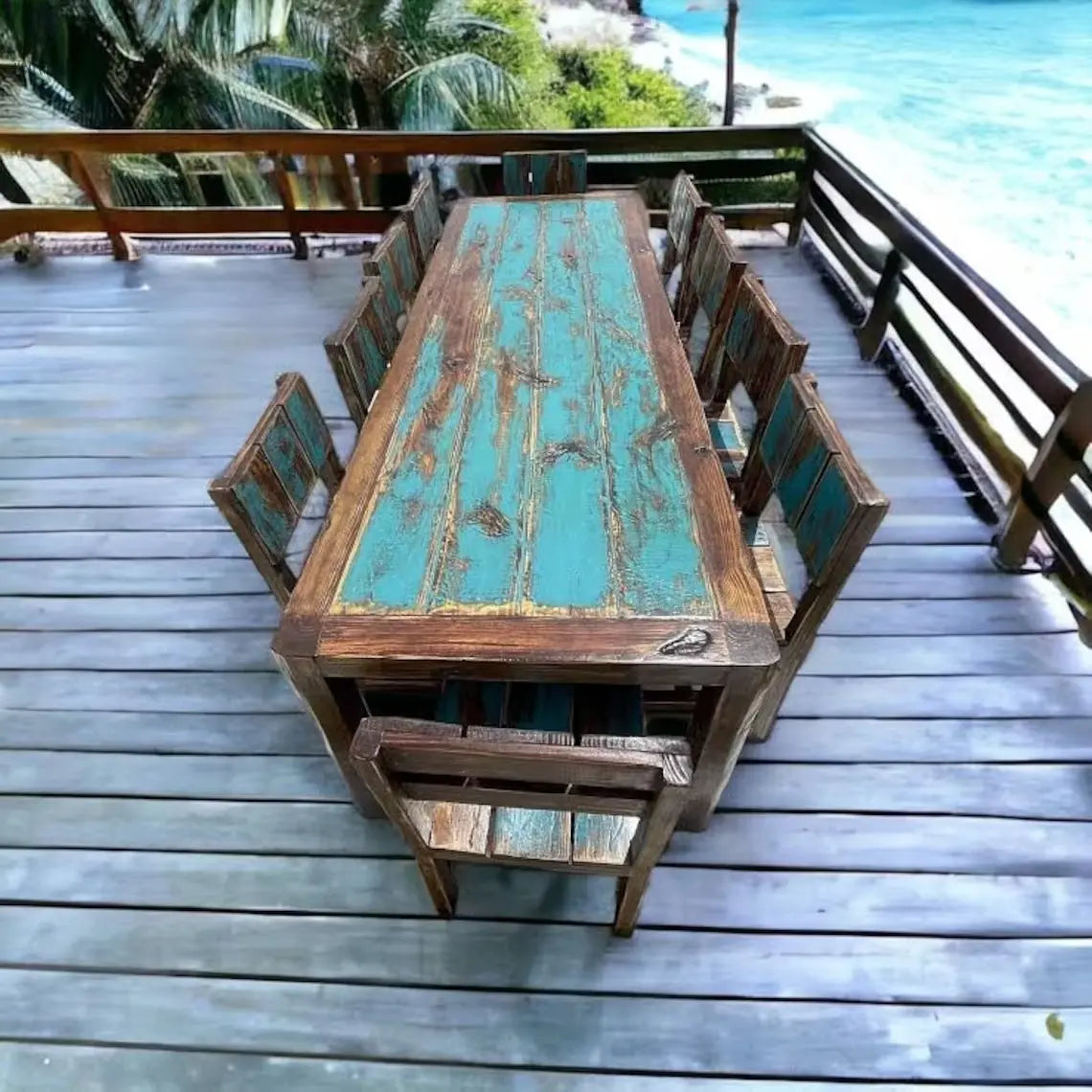 Top-down view of Red Cloak's reclaimed wood outdoor dining set with distressed teal planks and matching chairs on a deck