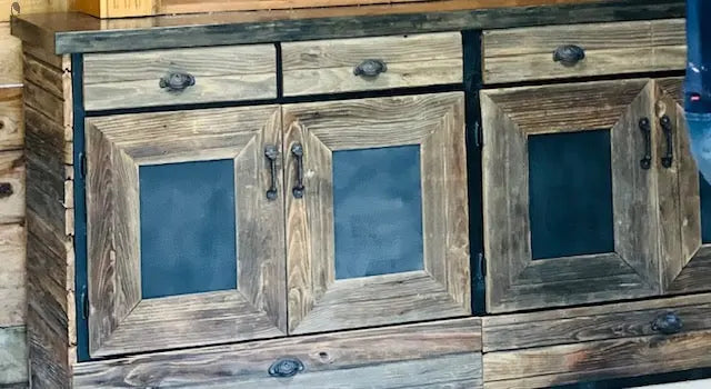 Detail shot of reclaimed wood back bar cabinet with black metal accents and distressed woodgrain finish.