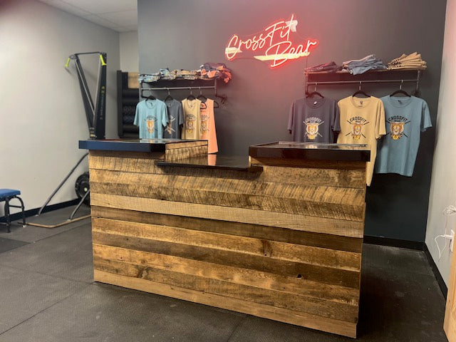 Rustic cash wrap counter made from reclaimed barnwood with a POS drop, shown in CrossFit Bear retail space