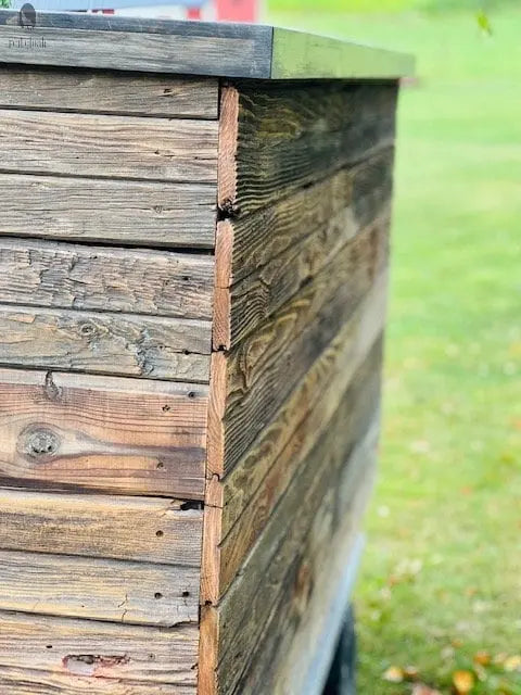Side detail of reclaimed wood kitchen island cabinet showing aged barnwood texture and joinery – Red Cloak Wood Designs