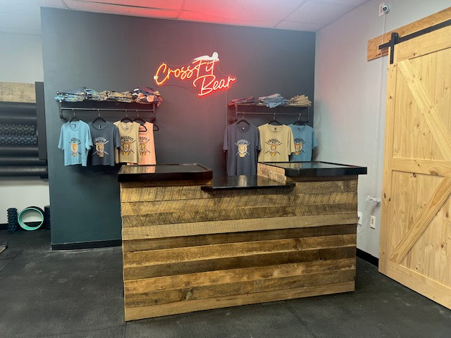 Reclaimed wood cash wrap counter with ADA drop section in boutique retail space at CrossFit Bear in Pennsylvania