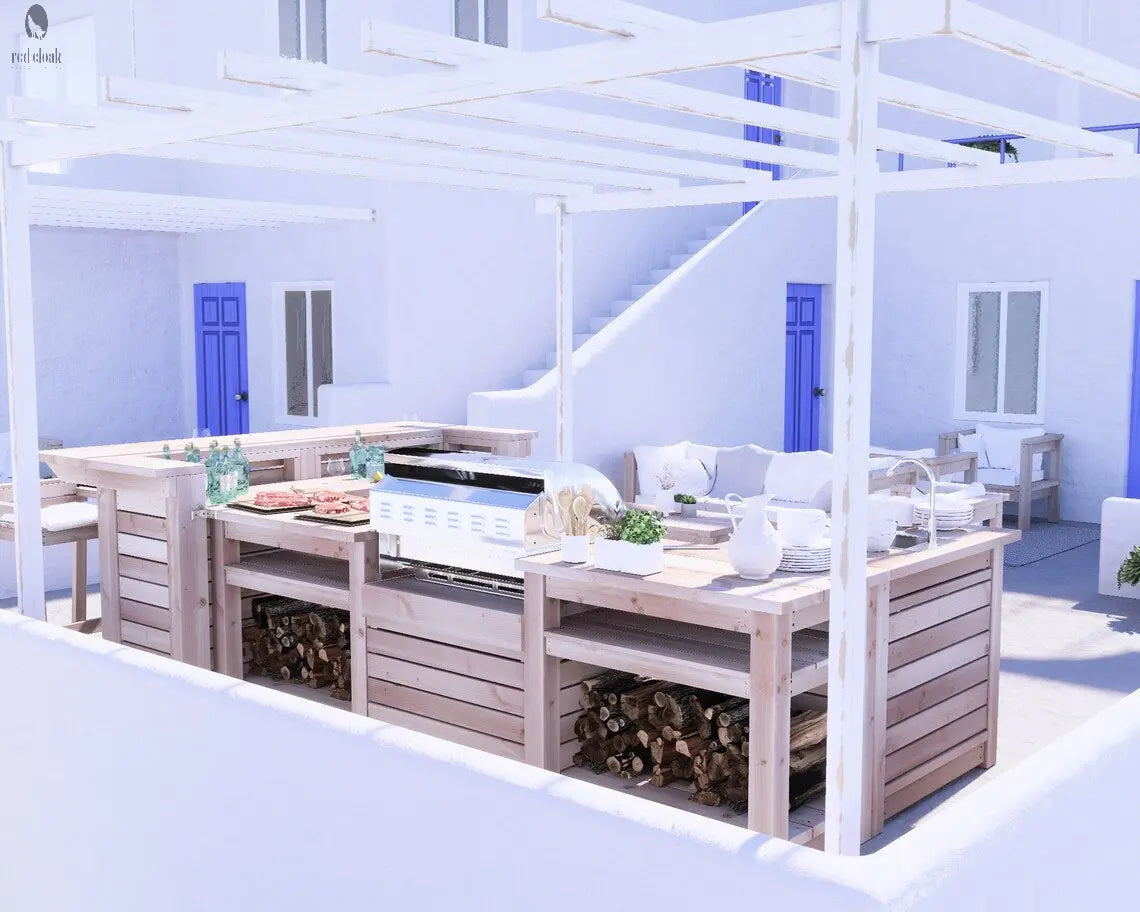 Full view of Red Cloak Outdoor Kitchen Bar under white pergola with built-in grill, natural wood finish, and stacked firewood in a coastal setting