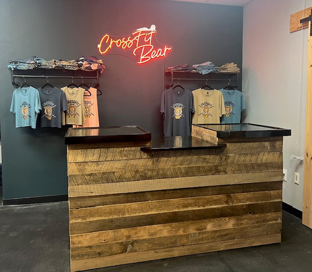 Front-facing shot of reclaimed barnwood retail counter with ADA drop section at CrossFit Bear