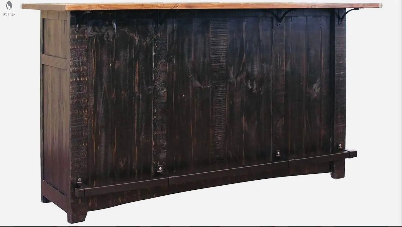 Rear panel of rustic wood kitchen island with footrest and deep dark stain, bar-style design