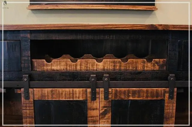 Wine bottle storage rack detail above sliding barn doors on reclaimed wood kitchen island