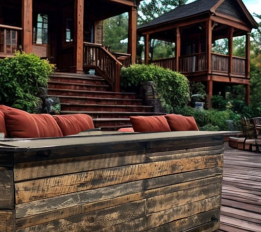 Custom barnwood outdoor bar by Red Cloak Home on a rustic fall patio with seating and wooden deck, perfect for backyard entertaining.