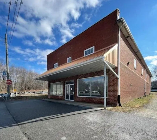 Exterior view of Red Cloak Wood Designs' new workshop and storefront in Pennsylvania with clear skies above