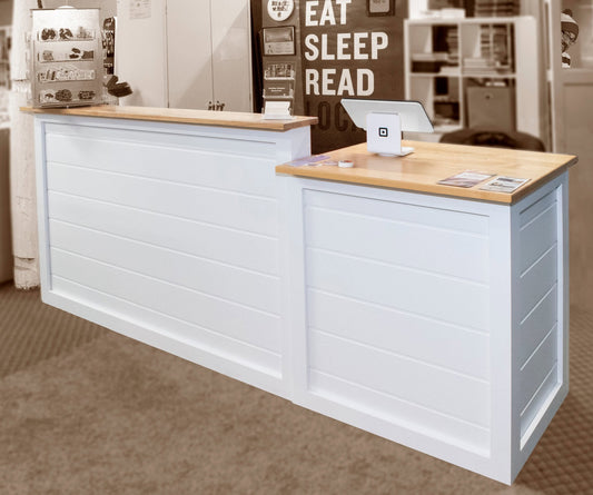 White retail checkout counter with wood top and POS station inside a bookstore custom made by Red Cloak Home