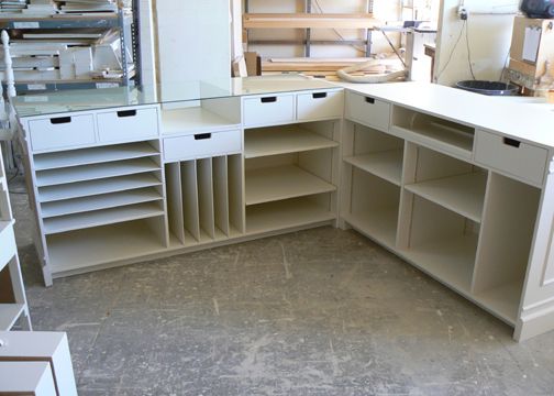 Rear gift wrap workstation with drawers, open shelving, paper storage, and cabinet space. Handmade by Red Cloak Home