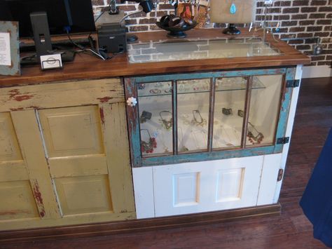 Reclaimed door retail counter with built-in glass merchandise display and wood countertop. Handmade by Red Cloak Home
