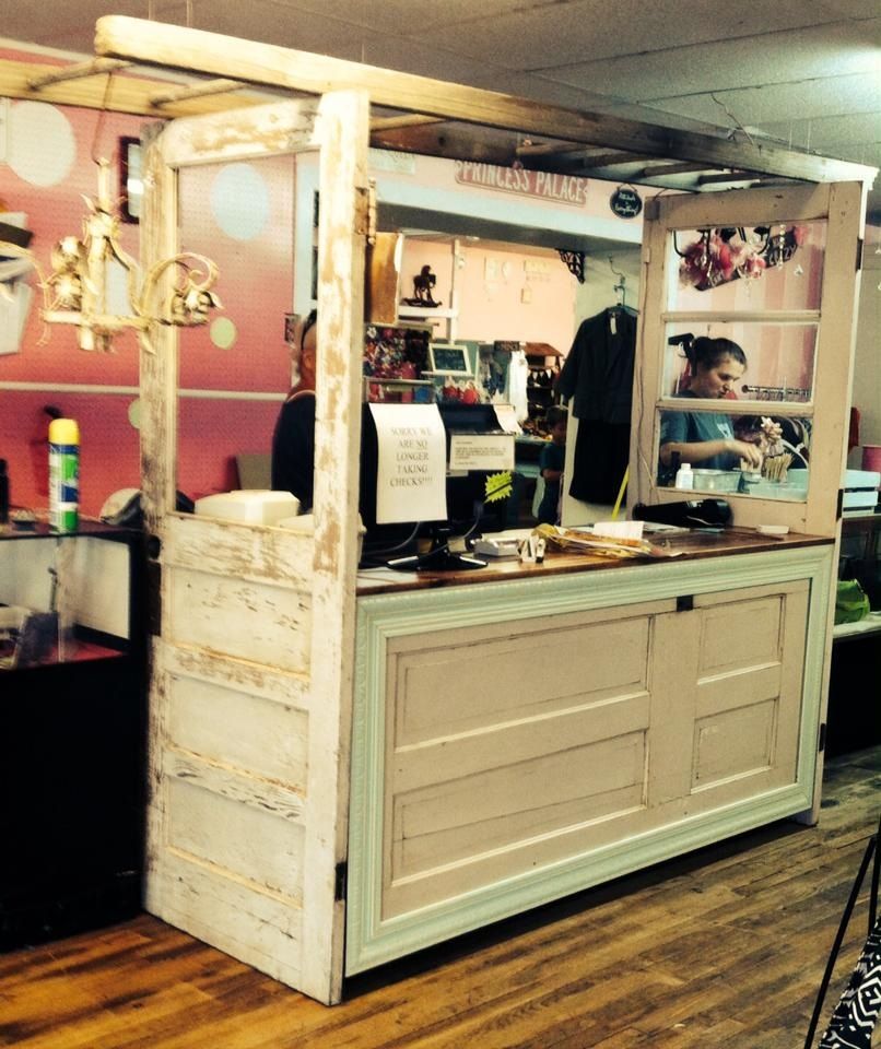 Custom retail checkout station built with reclaimed doors, overhead frame, and POS workspace. Handmade by Red cloak Home