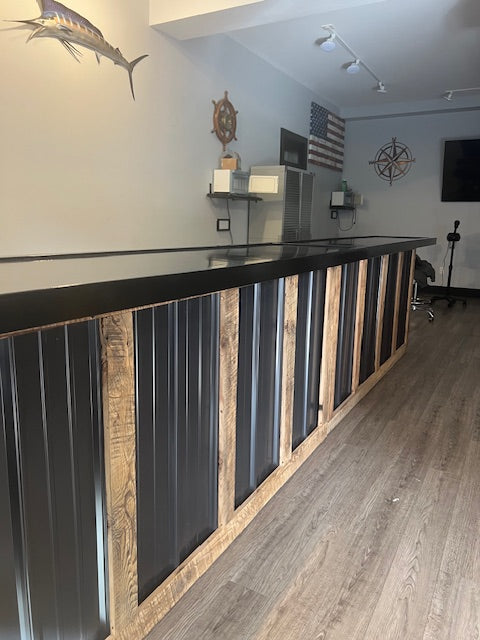 15 ft L-shaped commercial counter with wood framing and black metal panels, custom retail checkout counter with long service run and sealed countertop, USA