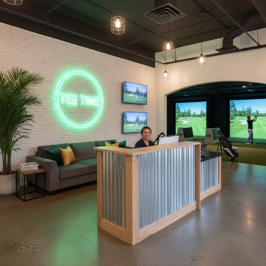 Custom industrial L-shaped reception desk with corrugated metal panels in a modern golf simulator lobby. Handmade by Red Cloak Home