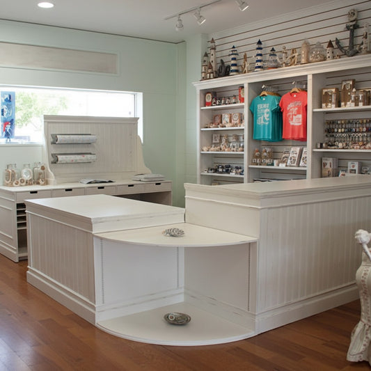 Custom U-shaped retail checkout counter with rounded display shelving in a coastal gift shop Handmade by Red cloak Home