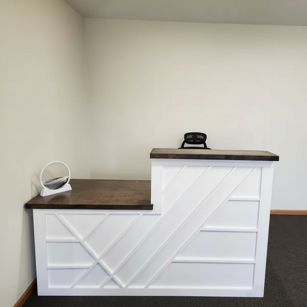 Compact white reception desk with dark wood tops, geometric front trim, and split-level workstation. Handmade by Red Cloak Home