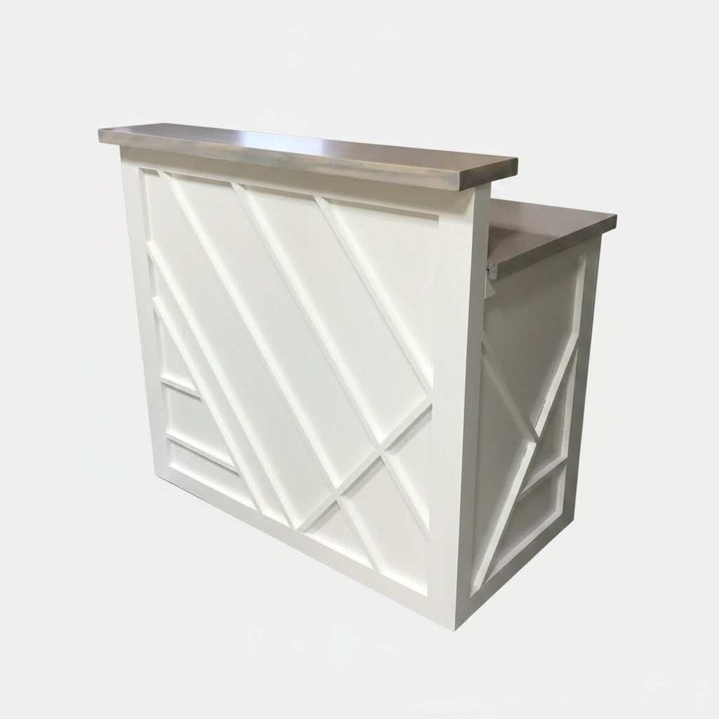 Angled view of a modern white reception counter with raised transaction ledge and geometric panel design. Handmade by Red Cloak Home