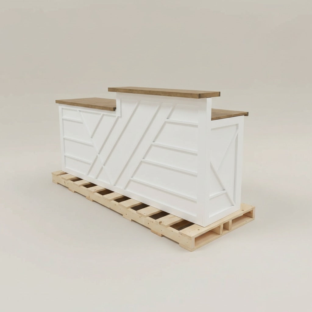 White custom reception desk with split-level wood tops shown secured on a shipping pallet. Handmade by Red Cloak Home
