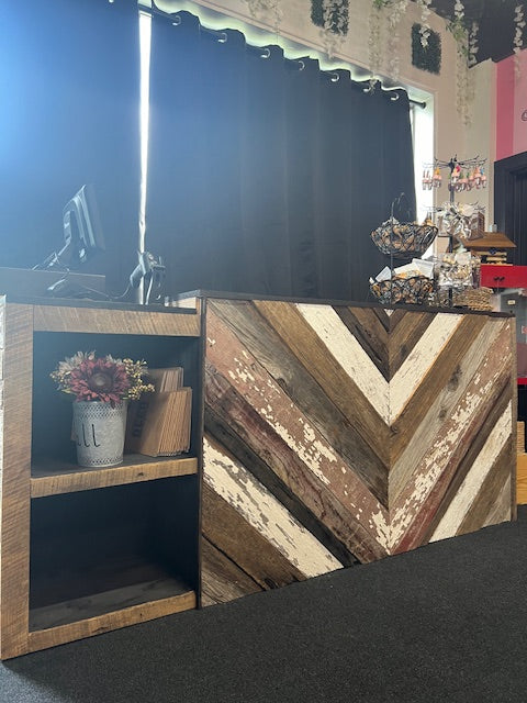 Angled view of barn wood retail counter with POS equipment and countertop decor – Red Cloak Home