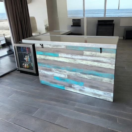 Reclaimed barn wood coastal bar with L shape design and glossy top, set on a deck with beach view by Red Cloak Home