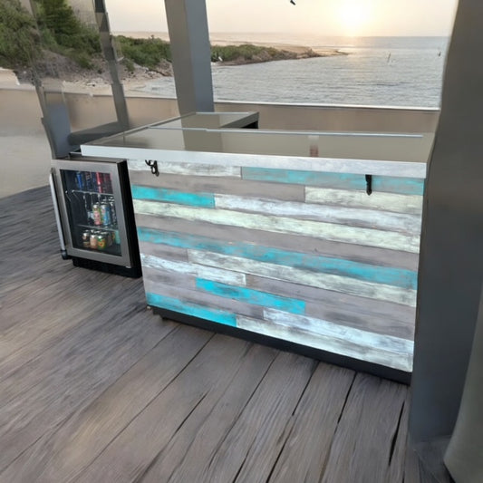 Reclaimed barnwood coastal bar with L shape design and glossy top, set on a deck with beach view by Red Cloak Wood Designs.