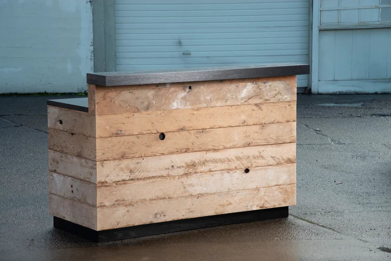 Front view of a reclaimed barnwood reception desk with black countertop and raised customer transaction ledge. Handmade by Red Cloak Home 