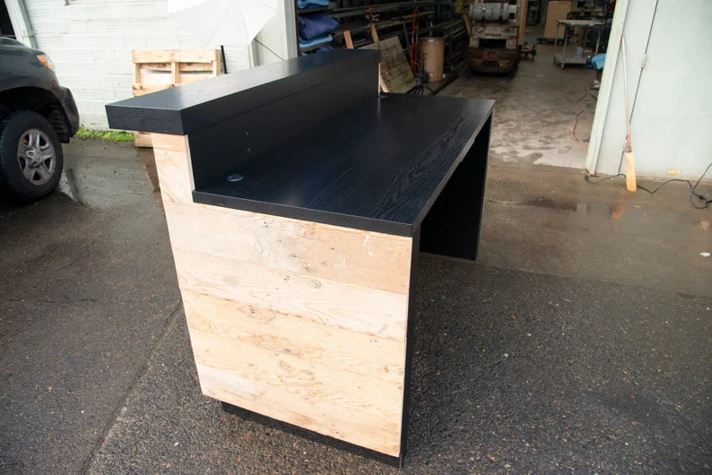 Employee-side view of a custom commercial reception desk with spacious work surface and raised front counter. Handmade by Red Cloak Home