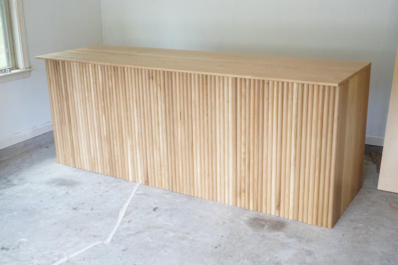 Wide view of a modern fluted wood cash wrap counter built for bakeries, boutiques, and retail stores. Handmade by Red Cloak Home