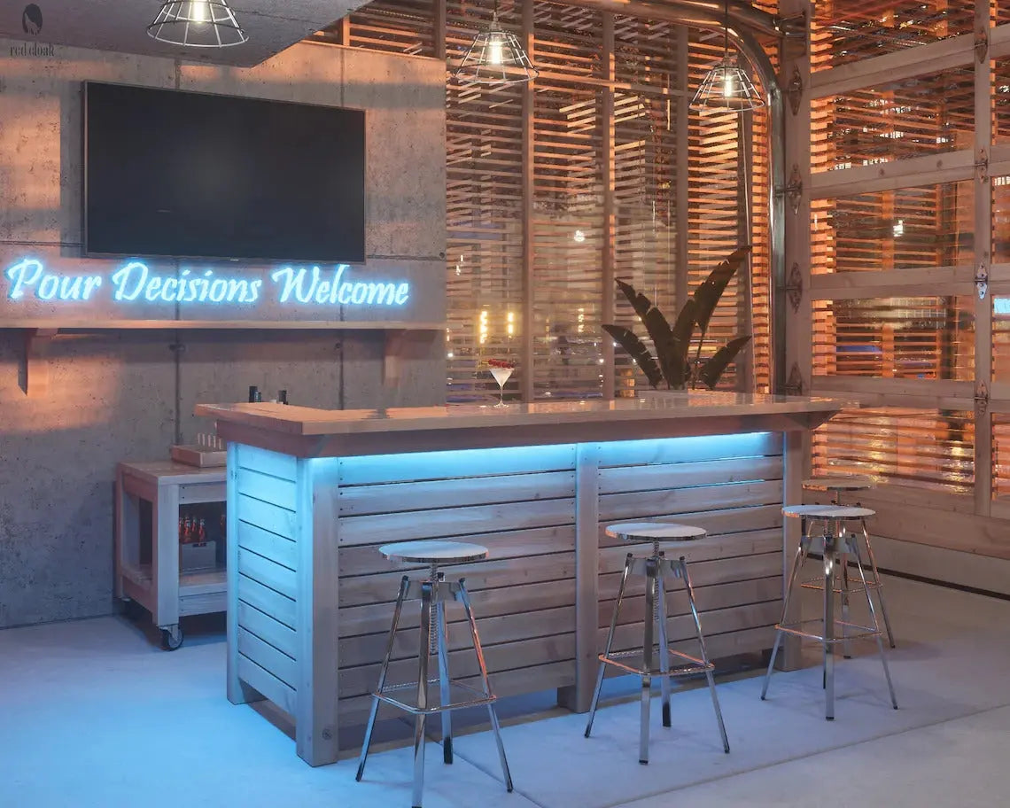 Custom indoor outdoor wood bar with LED lighting and “Pour Decisions Welcome” sign, built by Red Cloak Wood Designs