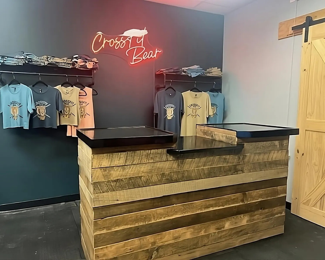 Reclaimed wood cash wrap counter with black top, designed for boutique or retail checkout area, handmade in the USA by Red Cloak Wood Designs