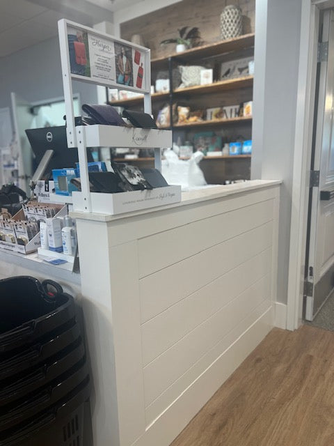 Reclaimed wood privacy wall checkout counter add-on in white, built by Red Cloak Wood Designs, shown in boutique retail space for added display and organization.