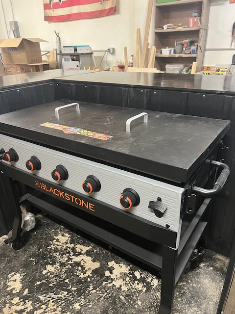 Full front view of Blackstone Bronco griddle installed in Red Cloak Home’s handmade bar, showing flush fit, handles, and rugged design finish.