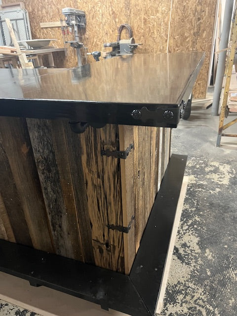 Close-up corner view of handmade Blackstone bar by Red Cloak Home, highlighting sealed wood top, metal trim, and rustic hardware details.