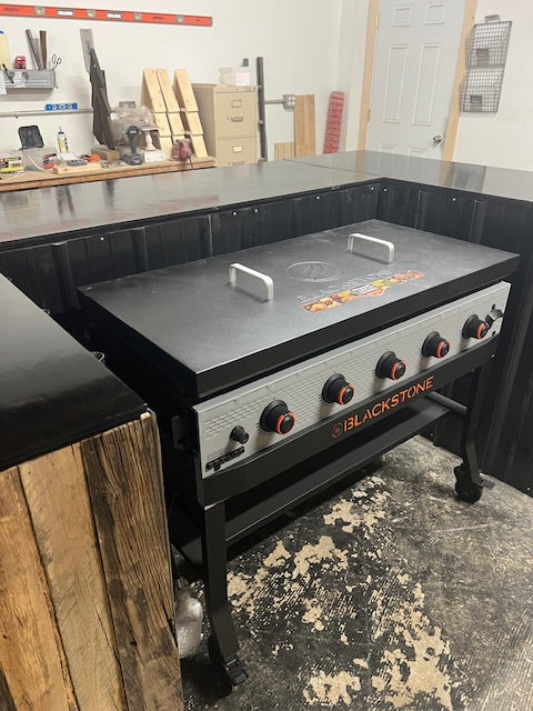 Blackstone Bronco 5-burner griddle installed in handmade wood bar by Red Cloak Home, showing custom fit and heat-shielded interior.