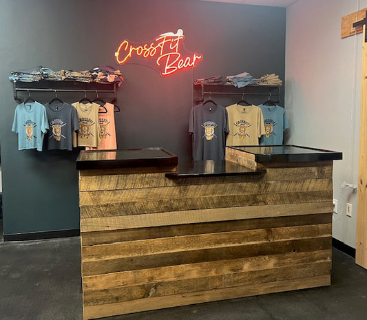 Front-facing shot of reclaimed barnwood retail counter with ADA drop section at CrossFit Bear