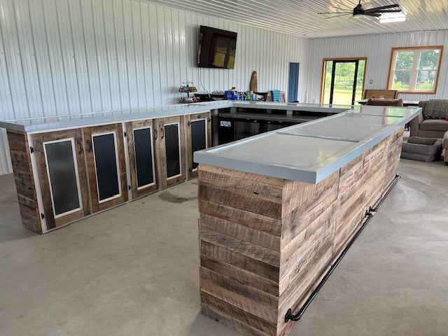U-shaped reclaimed wood bar featuring black metal cabinet doors and white countertop, handcrafted by Red Cloak Home