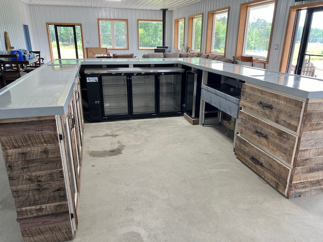 Interior view of U-shaped wood bar showing built-in 3-door cooler and storage drawers, handmade by Red Cloak Home