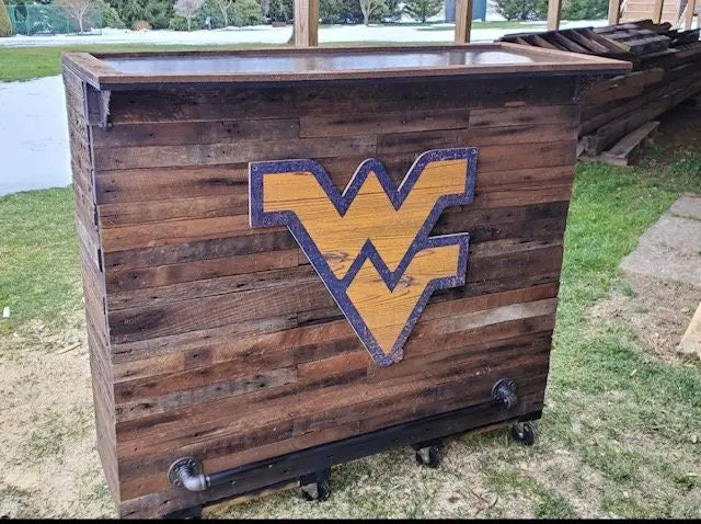 Reclaimed wood bar with WV logo and diagonal powder-coated metal foot rail